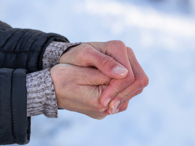 Cold-hands-against-snowy-background.jpg